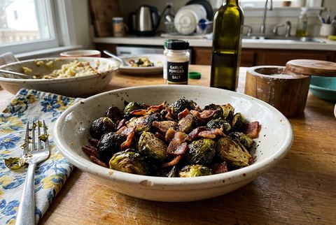 Charred air fryer brussels sprouts tossed with crispy bacon pieces