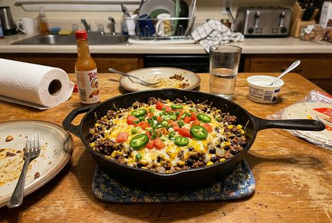Beef taco skillet with melted cheese, tomatoes, and jalapeño