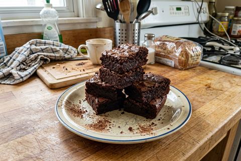 Fudgy chocolate brownies stacked to show dense crumb