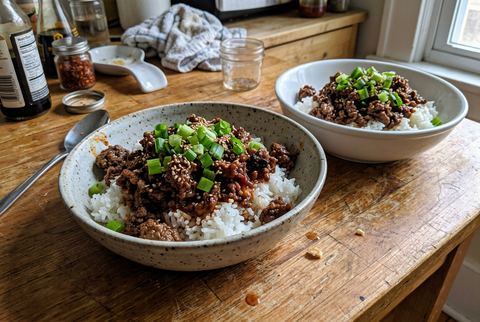Korean ground beef bowl over rice with green onions and sesame seeds