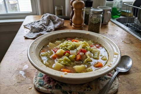 Old fashioned cabbage soup with vegetables in a clear broth