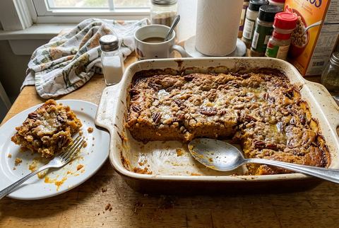 Pumpkin dump cake with golden buttery topping and a slice removed